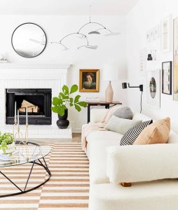 Bright apartment living room with thrifted furniture and decor.